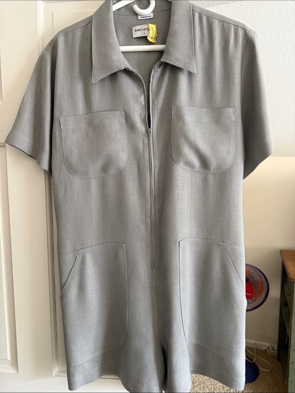 Light grey women’s romper with pockets and gathered back